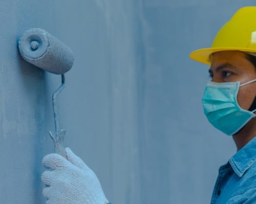 technician using paint roller